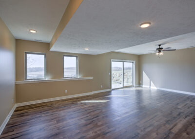 wooden floor windows sliding doors ceiling fan with lights cream walls