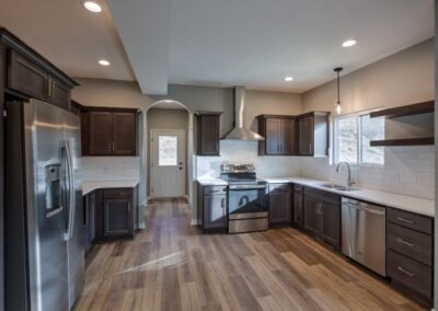 wide kitchen, wood flooring, stained wood kitchen cabinets