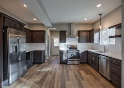 wide kitchen, wood flooring,stained wood kitchen cabinets