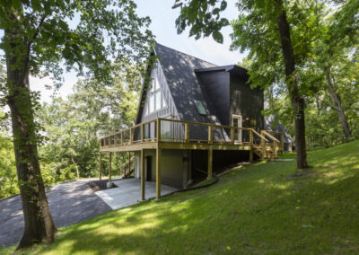 Modern A house with balcony, dark gray roof and wood sidings