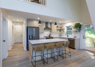 kitchen,kitchen island, bar stools,kitchen lights, wooden floor, white cabinets